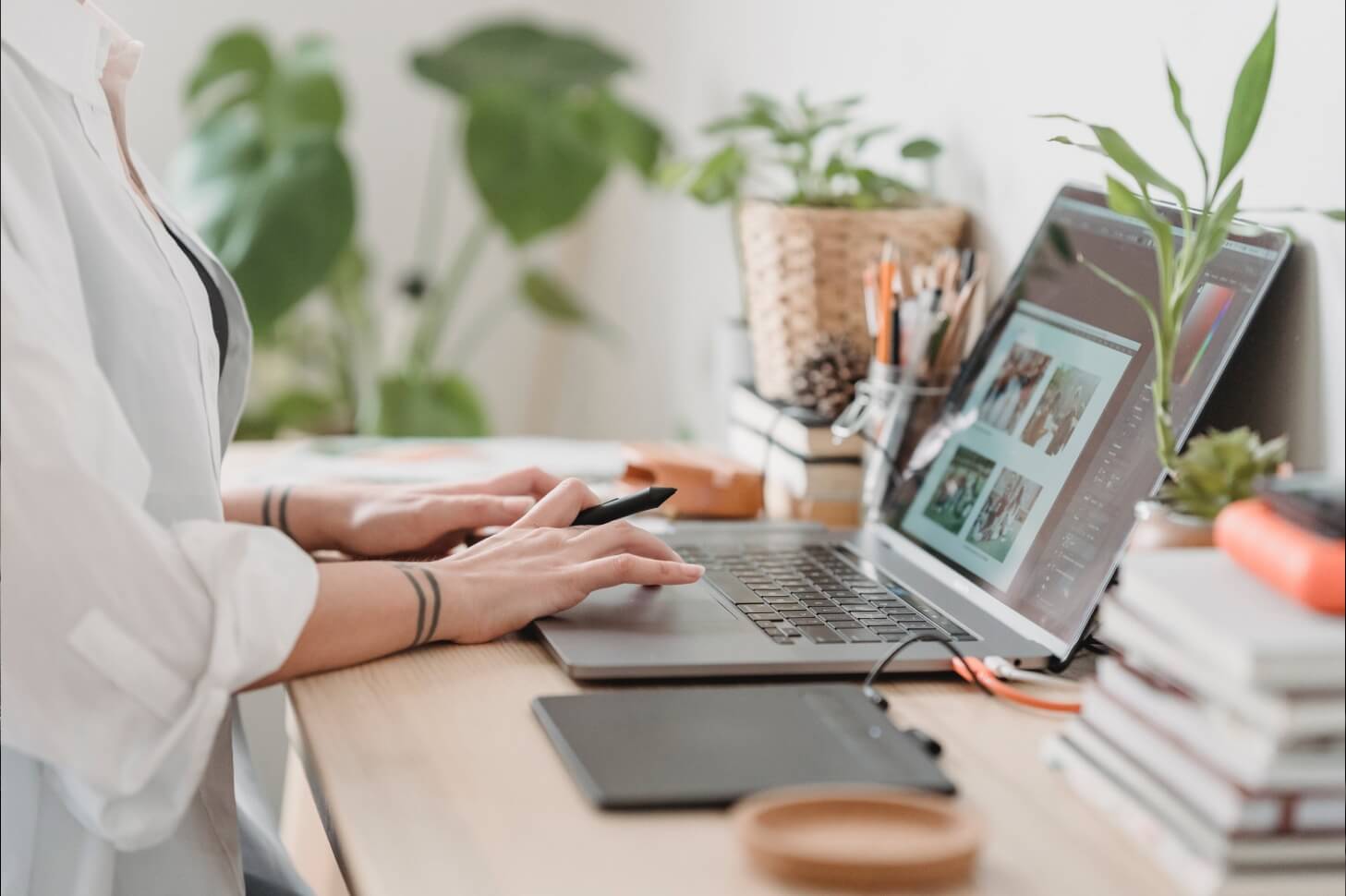 A person sitting at a desk with two laptops.