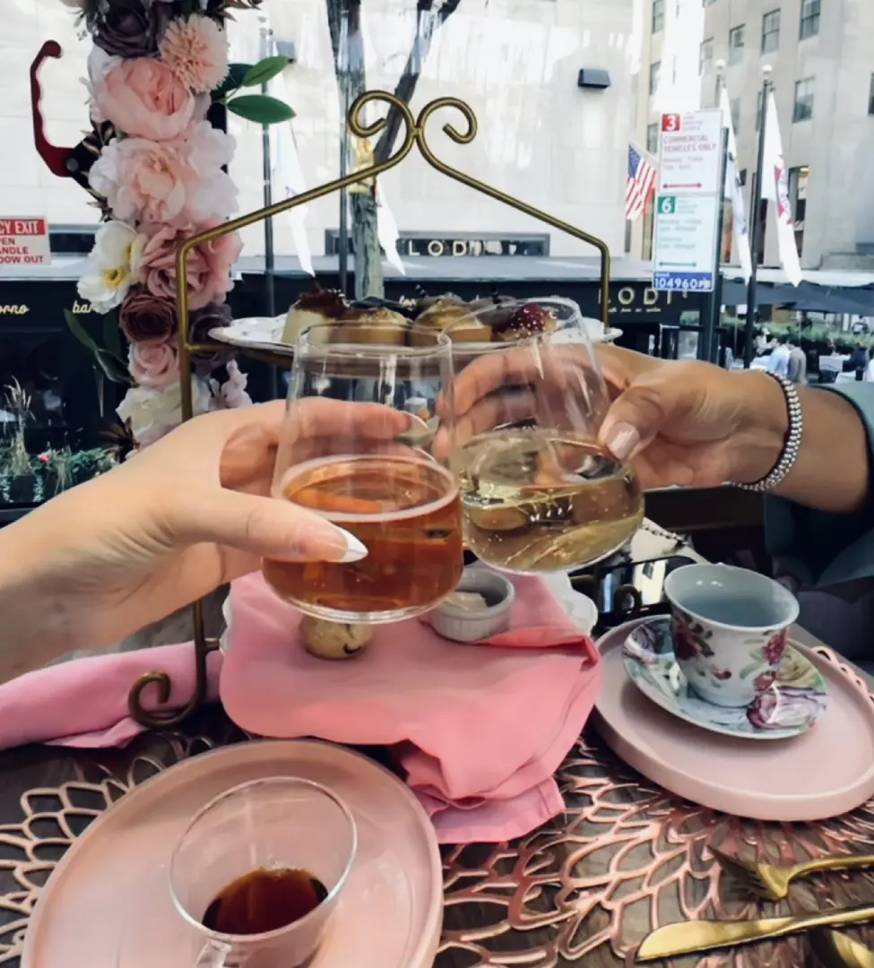 A group of people holding drinks at a table.